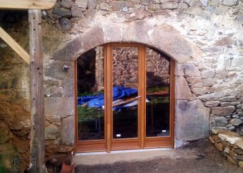 standard doors fitted in carved-stone entrance by B3KM EcoDesign