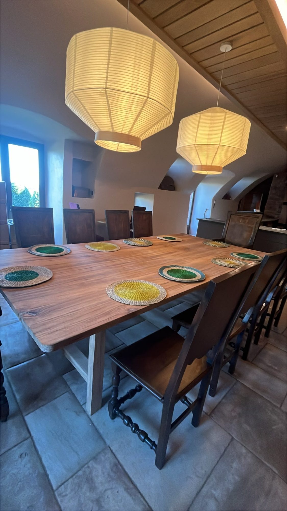 Large dining table laid for a meal by B3KM EcoDesign