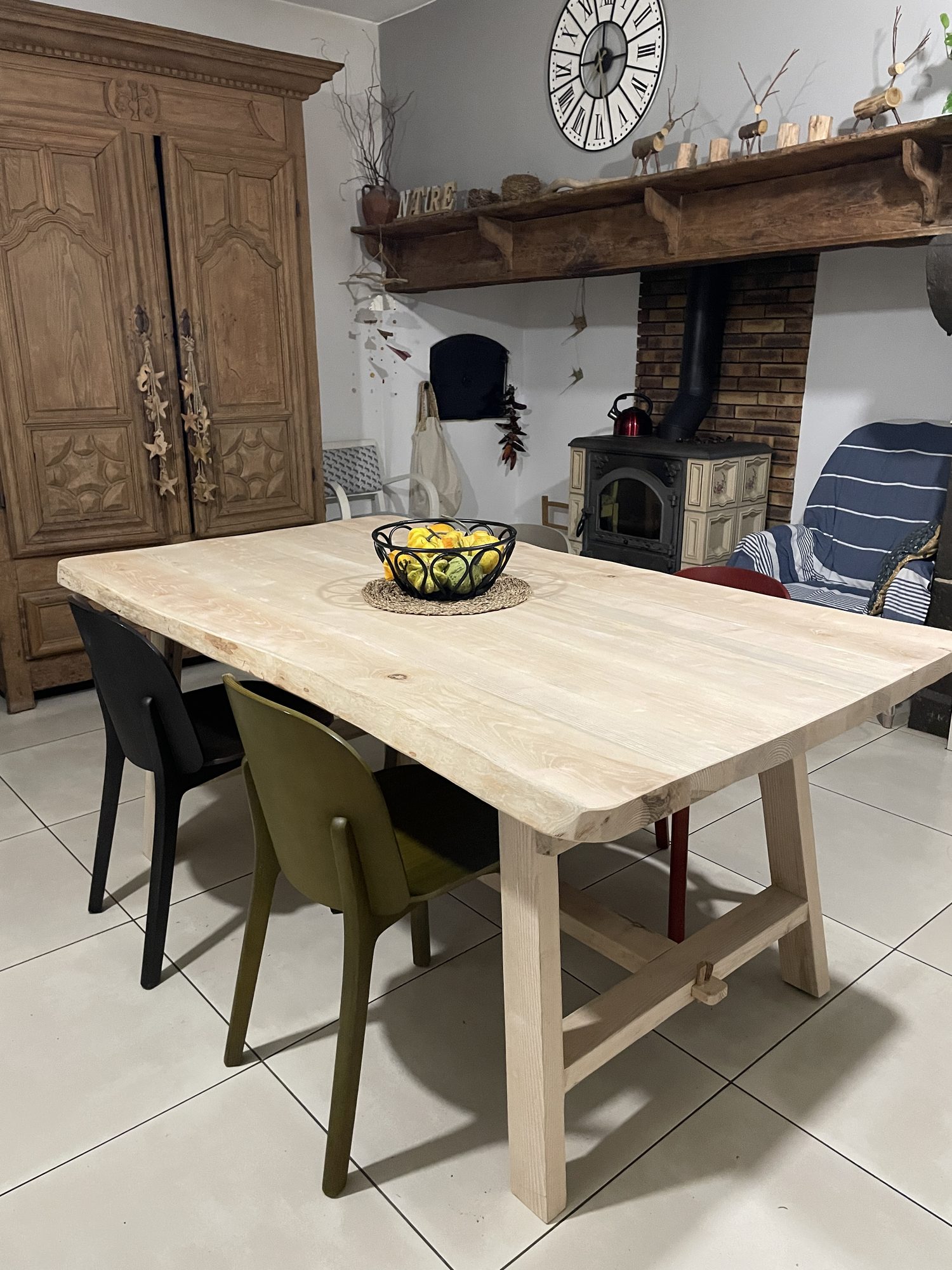 Live-edge table with chairs beside a wood stove by B3KM EcoDesign